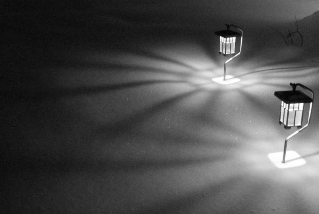 Lanterns radiate patterns of light on the snow